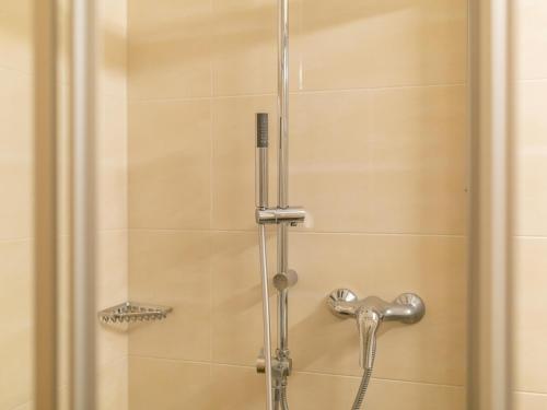 a shower with a glass door and a shower head at Bergjuwel Typ 2 in Fügen