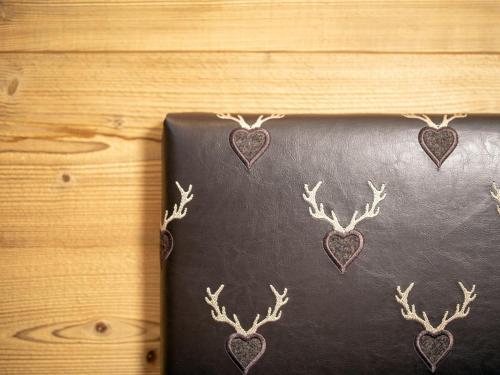 a black leather book with deer antlers on it at Bergjuwel in Fügen