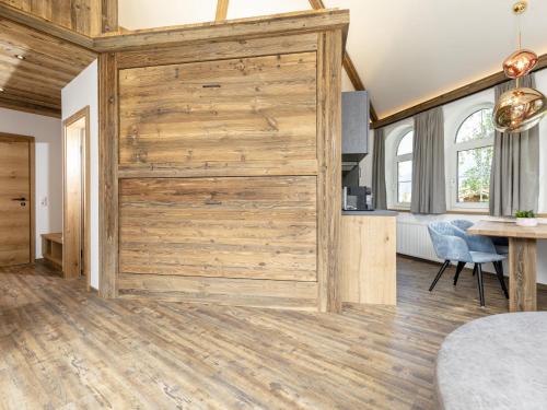 a large wooden door in a room with a table at Bergjuwel in Fügen