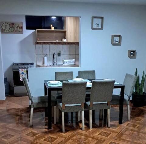 a dining room table and chairs in a kitchen at Lopez House in Lima