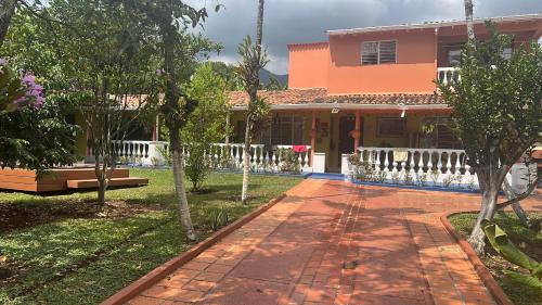 a house with a pathway in front of it at Villa El Rio in Cali