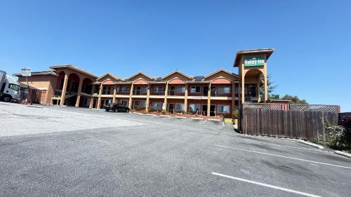 an empty parking lot in front of a hotel at Valley Inn in Watsonville
