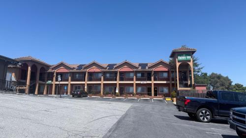 a parking lot in front of a hotel at Valley Inn in Watsonville
