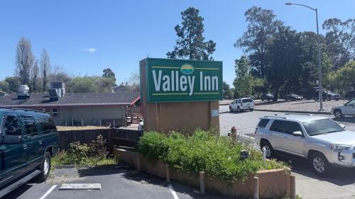 a sign for a valley inn in a parking lot at Valley Inn in Watsonville