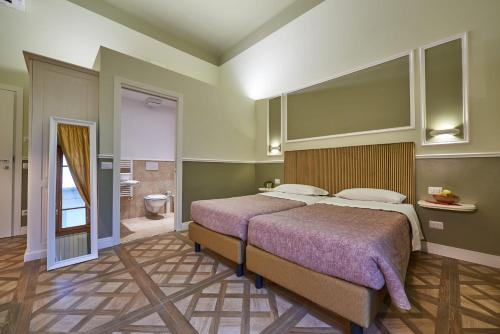 a bedroom with a large bed and a bathroom at B&B Le Stanze del Duomo in Florence