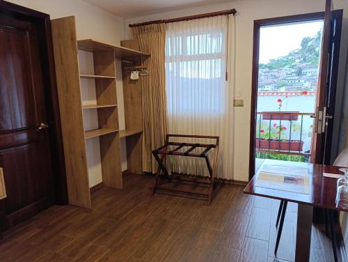a room with a table and a chair and a window at Casona Tobar Hotel in Quito