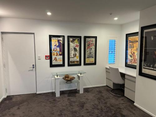 a room with a desk and posters on the wall at Perano Penthouse in Picton
