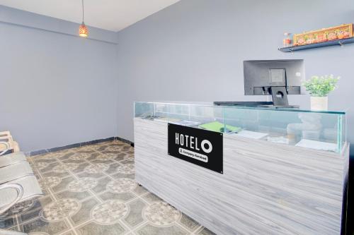 a reception desk with a nittilus sign on it at Super Hotel O Ramavarapadu Near PVR Icon in Vijayawada