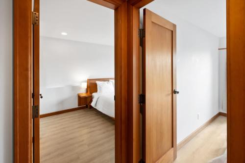 a bedroom with a door leading to a bed at The Cabins at Terrace Beach in Ucluelet