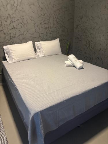 a bed with two towels on top of it at Pousada Água Salgada in Ilha de Boipeba