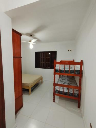 a room with a bed and a room with a table at Sitio canários 4 in Maricá