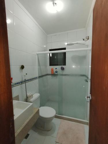 a bathroom with a shower and a toilet and a sink at Sitio canários 4 in Maricá