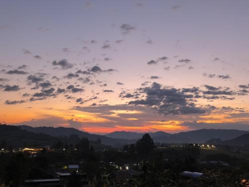 a sunset view of a city with mountains at San Gabriel Via Termales Santa Rosa in Santa Rosa de Cabal