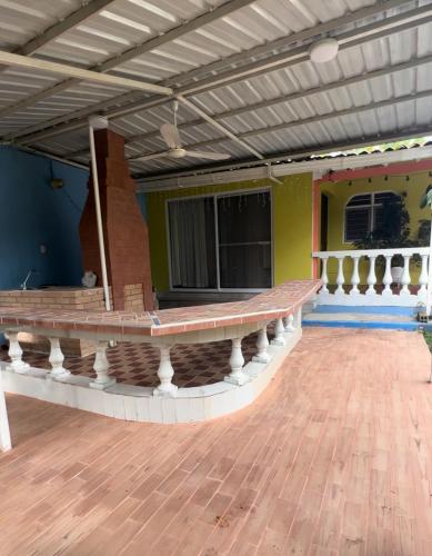 a porch of a house with a wooden floor at Villa El Rio in Cali