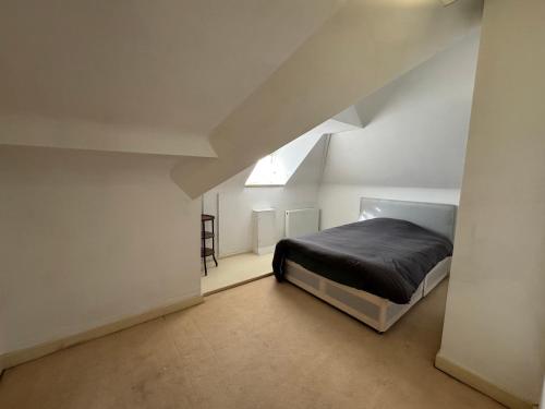 a bedroom with a bed in an attic at The Bishop in London