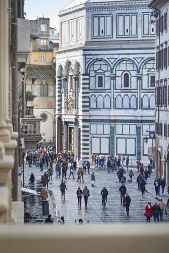 a group of people walking down a city street at B&B Le Stanze del Duomo in Florence