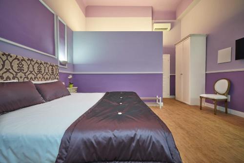 a bedroom with a large bed and a chair at B&B Le Stanze del Duomo in Florence