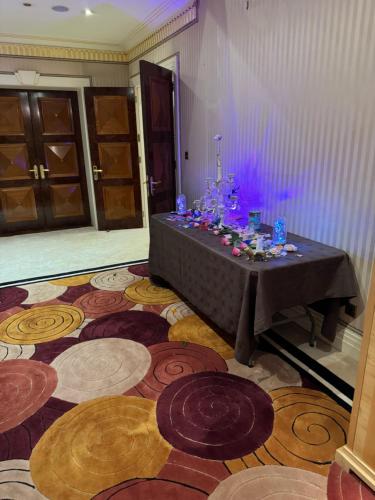 a table in a room with a floor with colorful circles at The Bishop in London