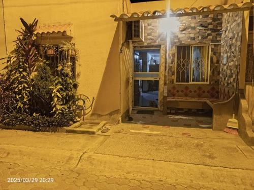 an entrance to a house at night with a door at Casa comoda con seguridad privada cerca de la playa in Presidente Tamayo