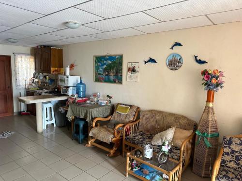 a living room with a couch and a table at Casa comoda con seguridad privada cerca de la playa in Presidente Tamayo
