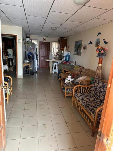 a living room with couches and chairs in a room at Casa comoda con seguridad privada cerca de la playa in Presidente Tamayo