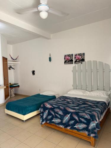 a bedroom with a bed and a ceiling fan at Terraza Tuxtla in Tuxtla Gutiérrez