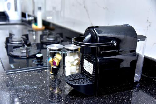 a coffee maker sitting on top of a kitchen counter at mehdia apartment and terrace parking fiber netfli in Kenitra
