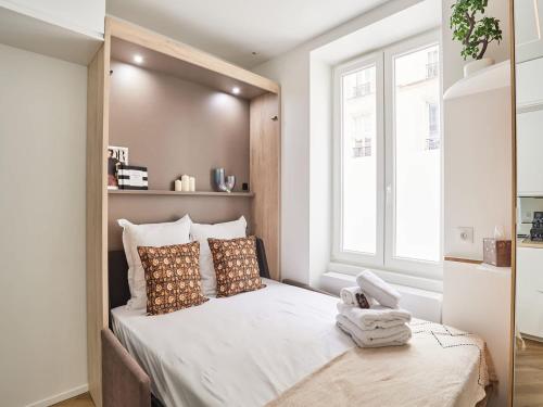 une chambre avec un grand lit avec une grande fenêtre dans l'établissement Superb studio Tour Eiffel Champ de Mars, à Paris