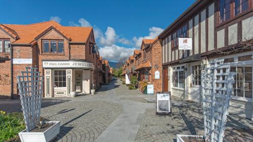 an empty street in a town with brick buildings at Monaco Village Apartment in Nelson