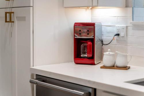 a red toaster sitting on top of a kitchen counter at Casa Evergreen - Outdoor Grille Patio with Putt in Leisure World