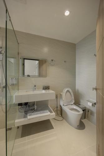 a bathroom with a toilet and a sink and a mirror at Diff Apartel Banglamphu in Bangkok