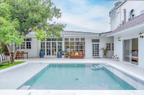 a swimming pool in the backyard of a house at APHRODITE POOL VILLA - Old City I 7 Bed Rooms I Daily Housekeeping in Chiang Mai
