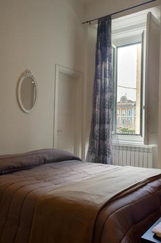 a bedroom with a bed and a window at Flora Rooms in Campobasso