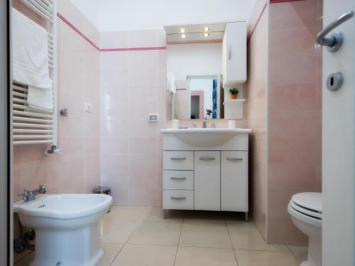 a bathroom with a white sink and a toilet at Flora Rooms in Campobasso