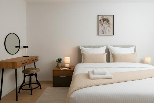 a bedroom with a bed and a desk with a mirror at Luxury Apartment Mona with Garden & Jacuzzi in Zadar, Borik in Zadar