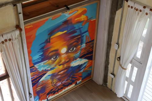 a painting on the door of a house at Tiny Village Cartagena Boutique Resort in Tierra Bomba