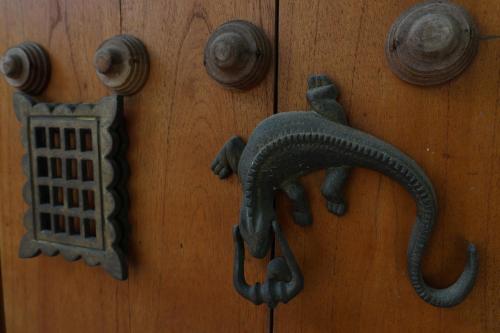 a wooden door with a metal door knocker on it at Tiny Village Cartagena Boutique Resort in Tierra Bomba