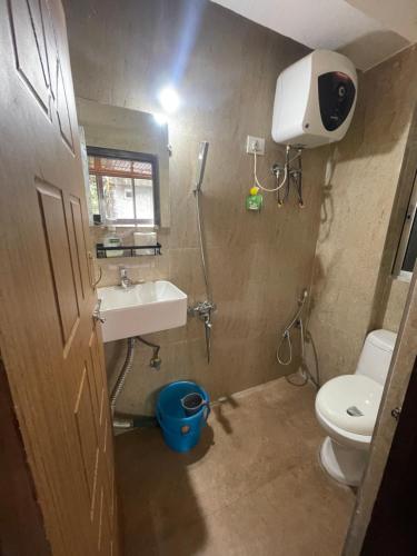 een kleine badkamer met toilet en wastafel bij Aamo Homestay in Darjeeling