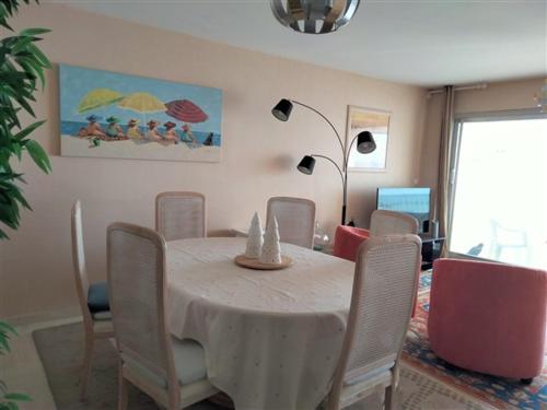 une salle à manger avec une table et des chaises blanches dans l'établissement Appartement T3 avec Terrasse Centre Plage - FR-1-331-33, à Les Sables-dʼOlonne