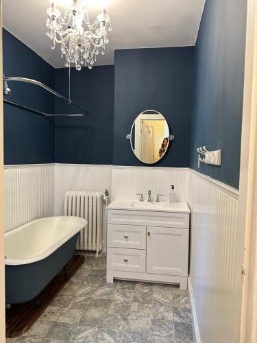 a bathroom with a tub and a sink and a mirror at 210 Main St in Ellsworth