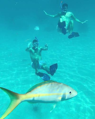 a group of people in the water with a fish at Florida Keys Boat Trips Multi Activity in Islamorada