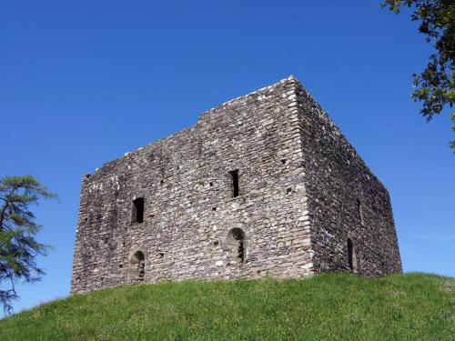 a stone building on top of a grassy hill at The Farmhouse in Tavistock