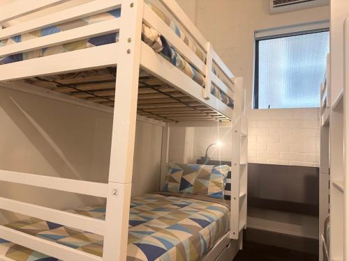 a bunk bed in a small room with a bunk bed in a house at Gamma Hotel in Auckland
