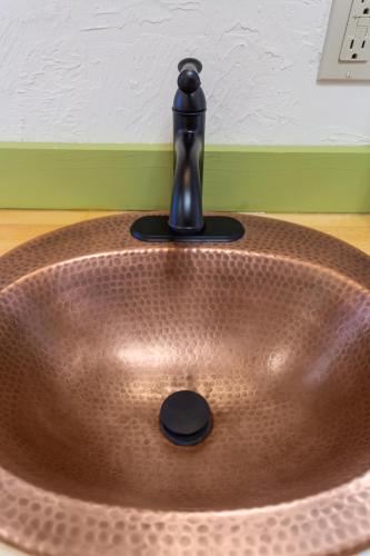 a bathroom sink with a faucet on top of it at Downtown Camden Hotel in Camden