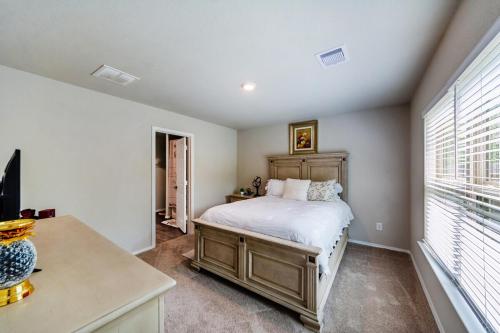 a bedroom with a bed and a large window at Rachel's Place in Conroe