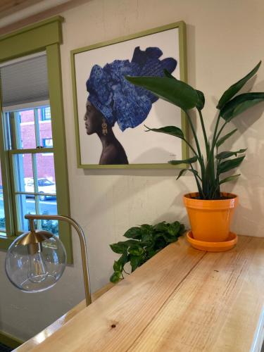 a wooden table with a plant on top of it at Downtown Camden Hotel in Camden