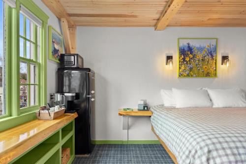 a room with a bed and a refrigerator in it at Downtown Camden Hotel in Camden