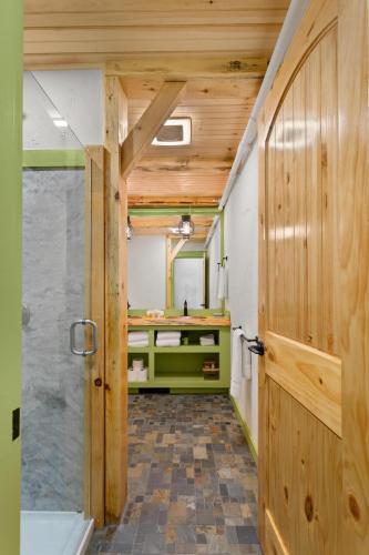 a bathroom with a shower and a wooden door at Downtown Camden Hotel in Camden