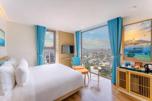a hotel room with a bed and a large window at Sala Quy Nhon Beach Hotel in Quy Nhon