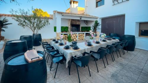 a long table with blue chairs and a table set up at Casa Rural Oasis in Zulema